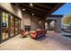 Outdoor living area with a fireplace, comfortable seating, and a covered patio at 7363 E Lower Wash Pass, Scottsdale, AZ 85266