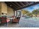 Inviting outdoor living space with stone fireplace, comfortable seating, and a refreshing pool with a serene water feature at 7363 E Lower Wash Pass, Scottsdale, AZ 85266