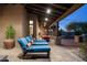 Covered patio features a lounge area with comfortable seating and views of the pool at 7363 E Lower Wash Pass, Scottsdale, AZ 85266