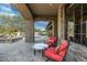 Elegant outdoor seating area with stone accents, offering a picturesque view of the pool and well-maintained landscaping at 7363 E Lower Wash Pass, Scottsdale, AZ 85266