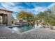 Serene pool area with a tranquil spa, surrounded by desert landscaping, creating a peaceful retreat for relaxation at 7363 E Lower Wash Pass, Scottsdale, AZ 85266