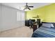 A bedroom with a green accent wall, and window with shutters at 7387 W Remuda Dr, Peoria, AZ 85383