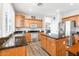 Well-lit kitchen with stainless steel appliances, granite counters, and wood cabinets at 7387 W Remuda Dr, Peoria, AZ 85383