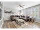 Bright living room with a ceiling fan and large sectional sofa at 7387 W Remuda Dr, Peoria, AZ 85383