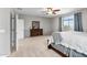 Carpeted main bedroom with ceiling fan, dresser, and large window with curtains at 7387 W Remuda Dr, Peoria, AZ 85383