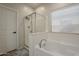 Bathroom showcasing a separate shower and tub, tile floors, and a privacy window at 7525 W Springfield Way, Florence, AZ 85132