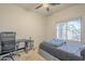 Comfortable bedroom with a neutral palette, ceiling fan and a large window for natural light at 7525 W Springfield Way, Florence, AZ 85132