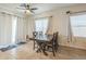 Bright dining room with a ceiling fan, tile floors, and a sliding glass door to the patio at 7525 W Springfield Way, Florence, AZ 85132