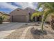 Inviting single-story home with a two-car garage, desert landscaping, and a charming walkway at 7525 W Springfield Way, Florence, AZ 85132