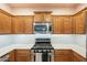 Beautiful kitchen with stainless steel appliances, granite countertops, and a gas range at 7525 W Springfield Way, Florence, AZ 85132