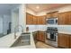 Well-equipped kitchen with stainless steel appliances, granite countertops, and ample cabinet space at 7525 W Springfield Way, Florence, AZ 85132