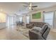 Open-concept living room with a view of the dining area and a comfortable sectional sofa at 7525 W Springfield Way, Florence, AZ 85132