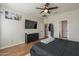 Spacious primary bedroom featuring modern decor, hardwood floors, and a ceiling fan at 7525 W Springfield Way, Florence, AZ 85132