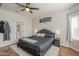 Well-lit primary bedroom featuring stylish decor, wood floors, and access to the bathroom at 7525 W Springfield Way, Florence, AZ 85132