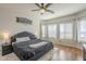 Primary bedroom with a ceiling fan, light colored walls, and a large window at 7525 W Springfield Way, Florence, AZ 85132