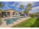 Inviting backyard pool with a waterfall feature, complemented by lush landscaping and outdoor seating at 7525 W Springfield Way, Florence, AZ 85132