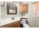 Bathroom with oak cabinets, updated fixtures, and great lighting at 7750 E Broadway Rd # 54, Mesa, AZ 85208