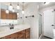 Well-lit bathroom featuring a sink, mirror, pendant lighting, and in-unit laundry at 7750 E Broadway Rd # 54, Mesa, AZ 85208