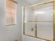 Bathroom featuring a glass shower enclosure and a window with blinds for natural light at 7750 E Broadway Rd # 54, Mesa, AZ 85208