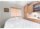 Comfortable bedroom featuring built-in cabinets, a window with blinds, and a plush bed at 7750 E Broadway Rd # 54, Mesa, AZ 85208