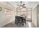 Bright dining room with a wooden table set on a patterned rug and many windows with natural light at 7750 E Broadway Rd # 54, Mesa, AZ 85208