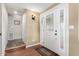 Bright entryway featuring a white door with glass panels, leading to a hallway with tile flooring at 7750 E Broadway Rd # 54, Mesa, AZ 85208