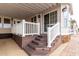 Beautiful home entrance with wooden steps, white railing, and a welcoming covered porch at 7750 E Broadway Rd # 54, Mesa, AZ 85208