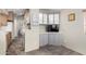 This kitchen features a pass through to another room and custom grey cabinets at 7750 E Broadway Rd # 54, Mesa, AZ 85208