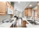 Galley kitchen with white appliances and cabinets with an adjacent dining area at 7750 E Broadway Rd # 54, Mesa, AZ 85208