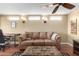 Cozy living room with a comfortable sofa, wood-look floors, and a ceiling fan at 7750 E Broadway Rd # 54, Mesa, AZ 85208