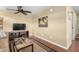 Cozy living room featuring a ceiling fan, television, and comfortable seating for relaxing and entertainment at 7750 E Broadway Rd # 54, Mesa, AZ 85208