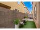 Enclosed backyard featuring a patio area with artificial turf at 7840 W Bonitos Dr, Phoenix, AZ 85035