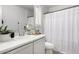 Clean bathroom with white cabinetry, a tub and shower combo, and a large mirror at 7840 W Bonitos Dr, Phoenix, AZ 85035