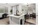 Bright kitchen island featuring a sleek sink and modern faucet with space for pet bed at 7840 W Bonitos Dr, Phoenix, AZ 85035