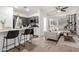 Bright living room with an open layout, connecting seamlessly to the modern kitchen and staircase at 7840 W Bonitos Dr, Phoenix, AZ 85035