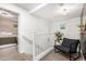 Upstairs loft featuring neutral colors, a comfortable chair, and a decorative plant at 7840 W Bonitos Dr, Phoenix, AZ 85035