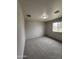 A neutral bedroom with plush carpeting and a window providing natural light and view to the outside at 7955 W Mackenzie Dr, Phoenix, AZ 85033