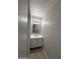 Clean powder room with modern vanity, mirror, and lighting fixtures at 7955 W Mackenzie Dr, Phoenix, AZ 85033