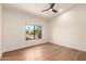 Bright bedroom with a ceiling fan, wood floor and a street view from the window at 8005 N Via De Lago --, Scottsdale, AZ 85258