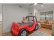 bedroom with hardwood floors, a red racecar bed, a leather couch and ceiling fan at 8005 N Via De Lago --, Scottsdale, AZ 85258