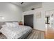 Bedroom with a white patterned comforter, hardwood floors and black closet doors at 8005 N Via De Lago --, Scottsdale, AZ 85258