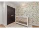 Bright Bedroom featuring animal-themed wallpaper, crib, modern light fixture, and black closet doors at 8005 N Via De Lago --, Scottsdale, AZ 85258