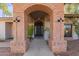 Close up of the brick archway entryway with a dark door and stylish outdoor lighting at 8005 N Via De Lago --, Scottsdale, AZ 85258