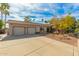 Spacious three-car garage with a concrete driveway and desert landscaping at 8005 N Via De Lago --, Scottsdale, AZ 85258