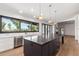 Open kitchen design with a dark island, marble countertops, stainless steel appliances, and natural light at 8005 N Via De Lago --, Scottsdale, AZ 85258