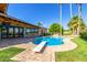 Backyard swimming pool with brick patio, tall palm trees, diving board and lush green lawn at 8005 N Via De Lago --, Scottsdale, AZ 85258
