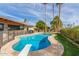 Inviting swimming pool with diving board, surrounded by green grass and palm trees at 8005 N Via De Lago --, Scottsdale, AZ 85258