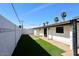 Backyard with white brick walls, artificial turf, and a shade structure at 8335 E Montecito Ave, Scottsdale, AZ 85251