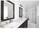 Bathroom featuring double sinks, marble countertops, and a glass enclosed shower at 8335 E Montecito Ave, Scottsdale, AZ 85251