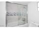 Bathroom featuring white tile, decorative tile, and a shower over tub combo at 8335 E Montecito Ave, Scottsdale, AZ 85251